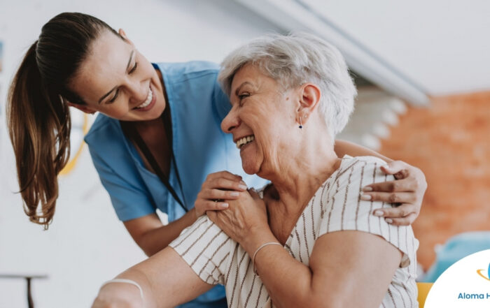 A female caregiver helping an older woman with stroke recovery at home.