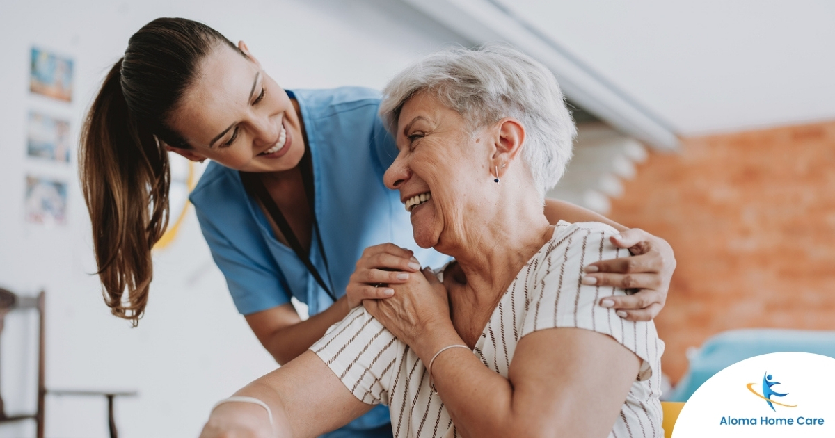 A female caregiver helping an older woman with stroke recovery at home.